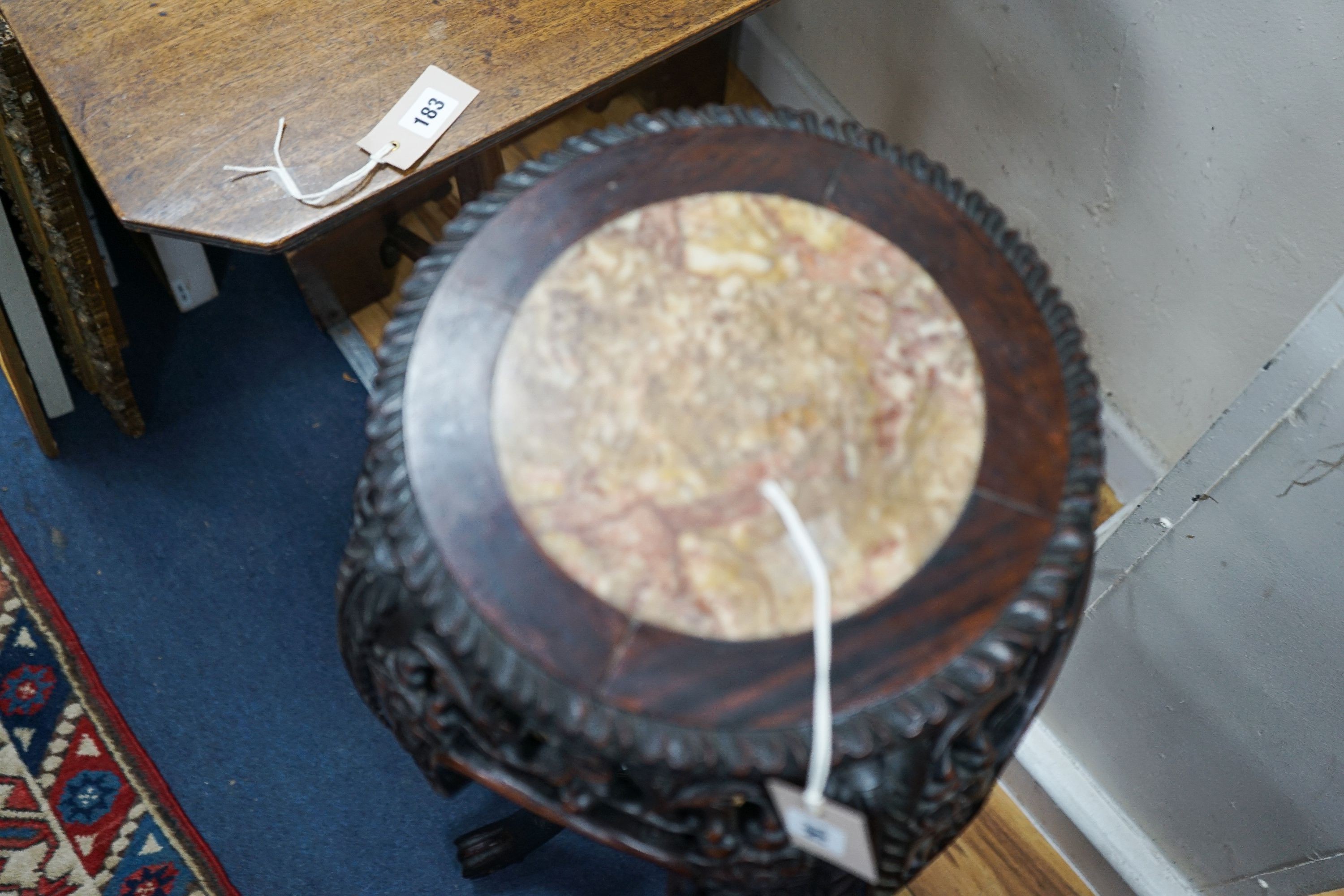 A Chinese circular marble top carved padouk jardiniere stand, height 91cm